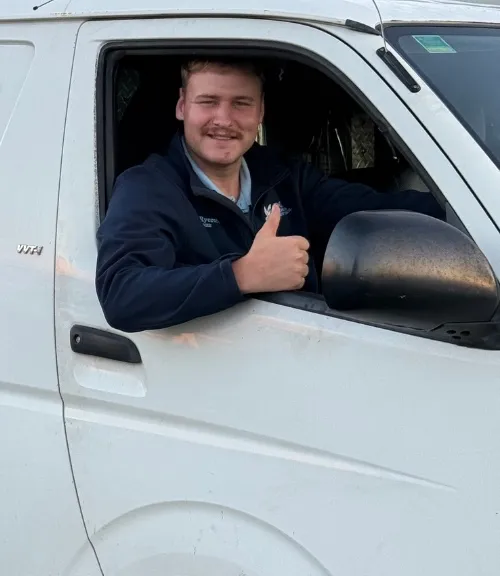Ben smiling and giving a thumbs up from the driver’s window of his van